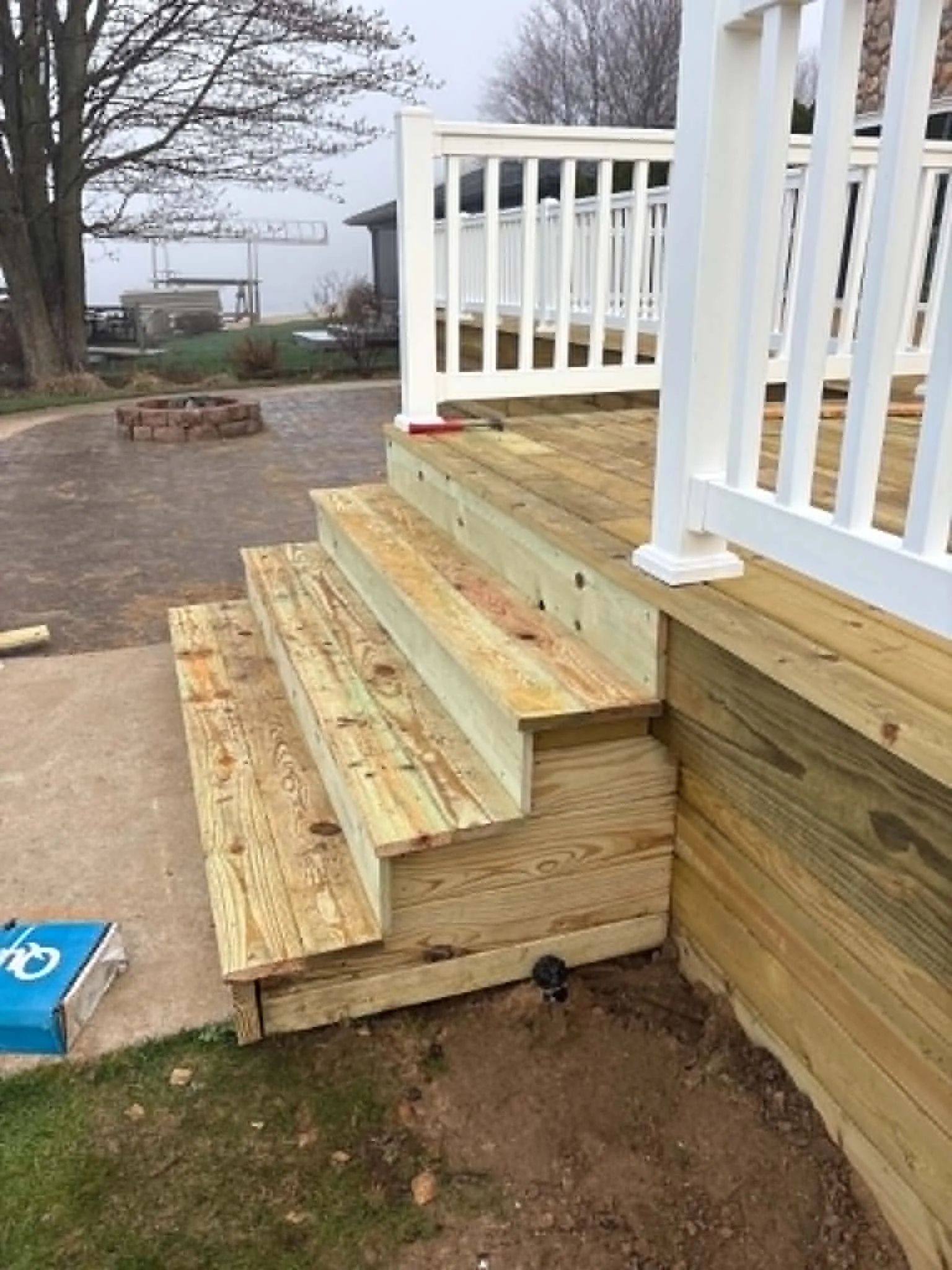 New pressure-treated deck stairs and white railing
