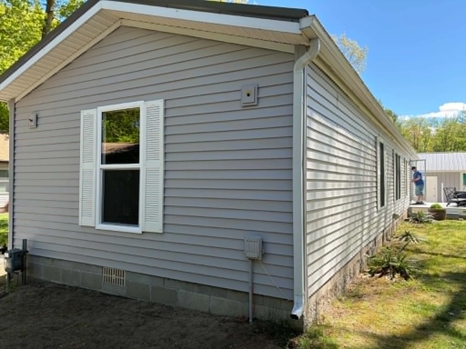 Home exterior with updated gray siding and white trim
