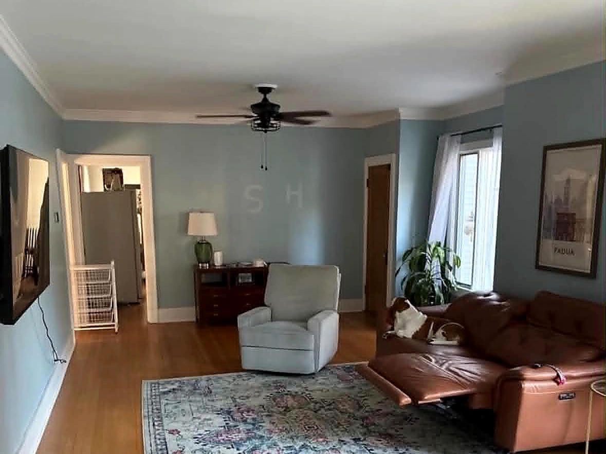 Living room before renovation with a solid rear wall and narrow doorway into the kitchen